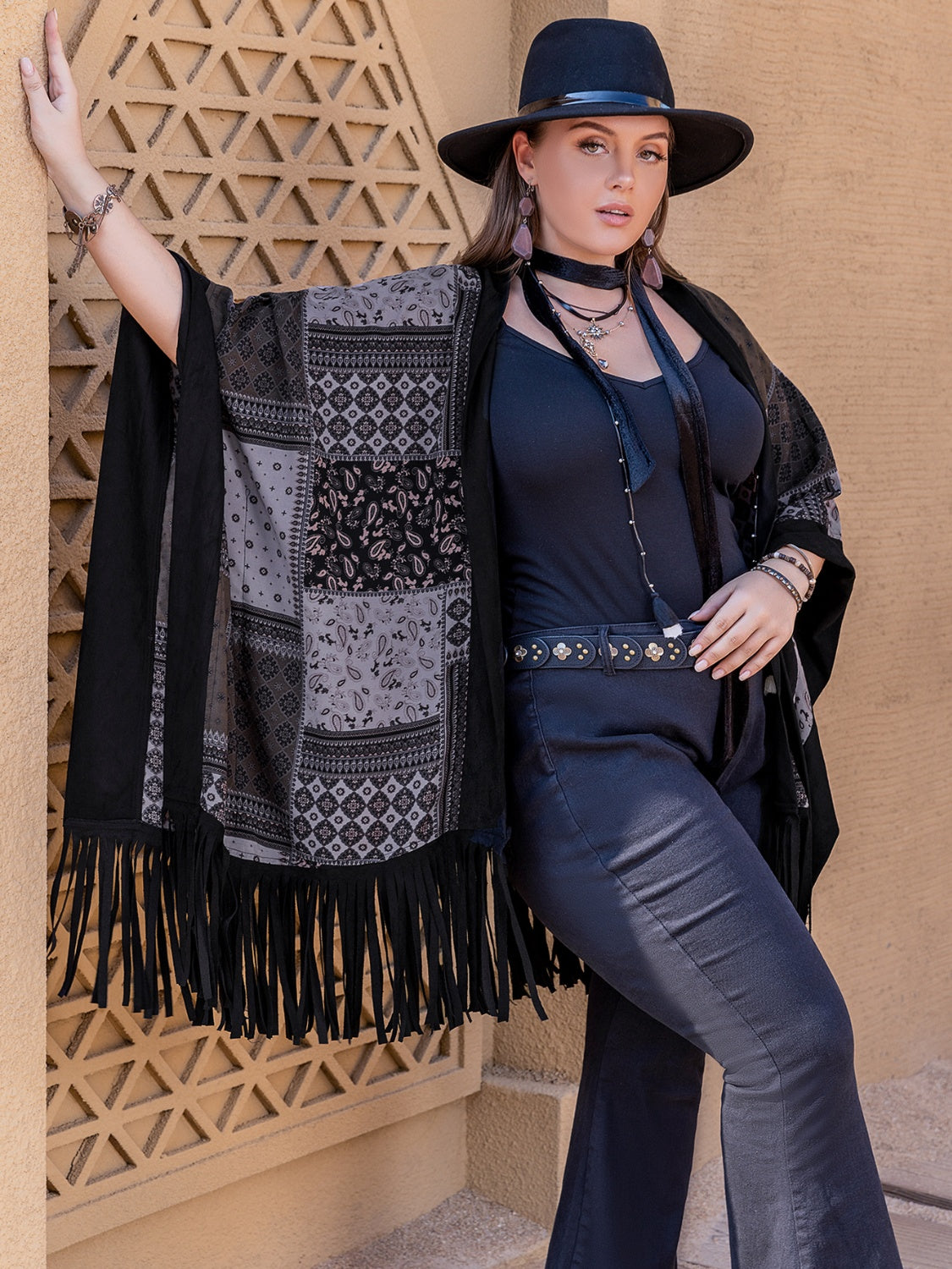 Model wearing black plus size open front poncho cover up