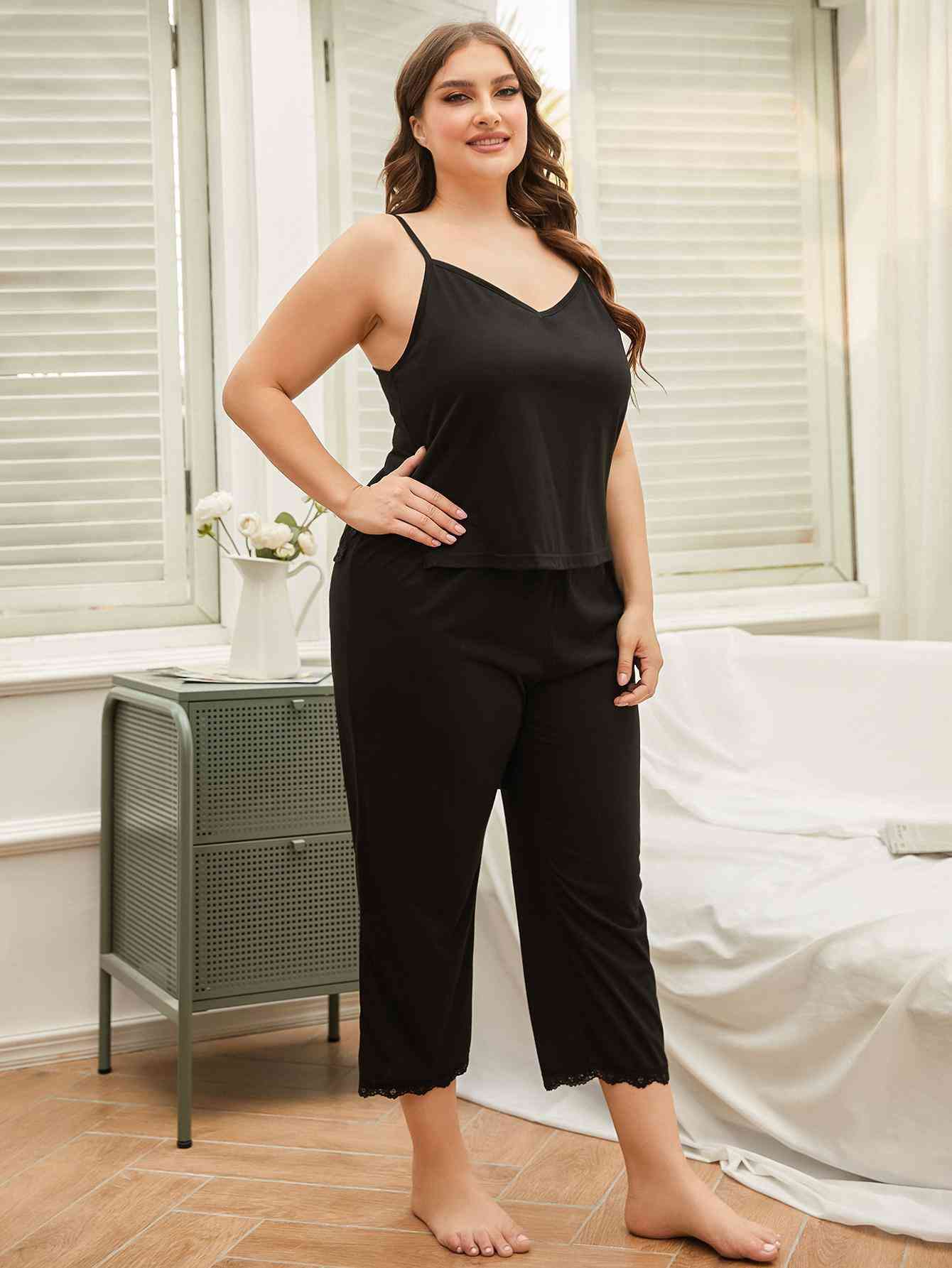 Model wearing black spaghetti strap pajama set