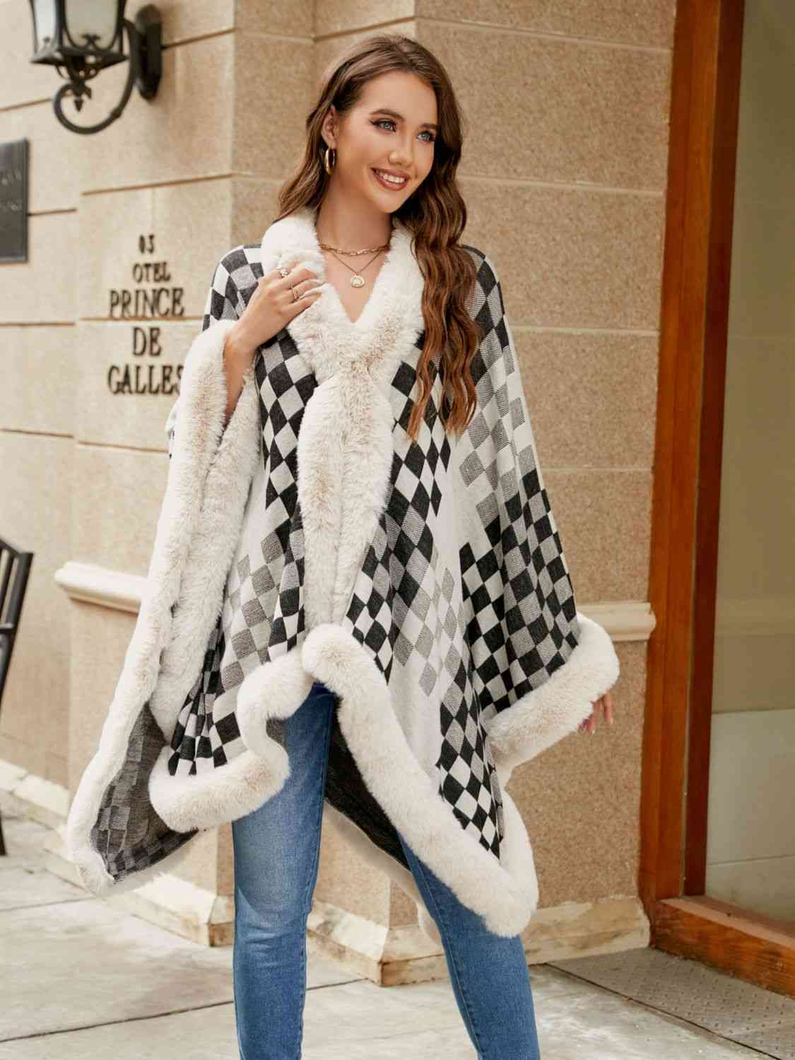 Model wearing checkered poncho with faux fur trim