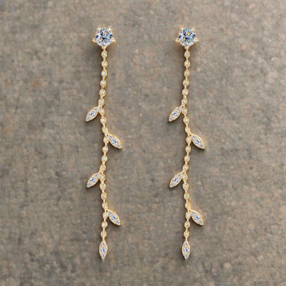 Moissanite drop earrings set in gold plated sterling leaf setting