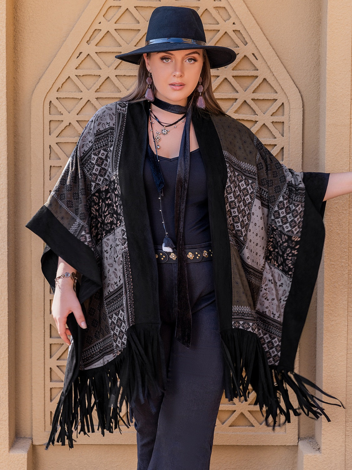 Model wearing black plus size open front poncho cover up