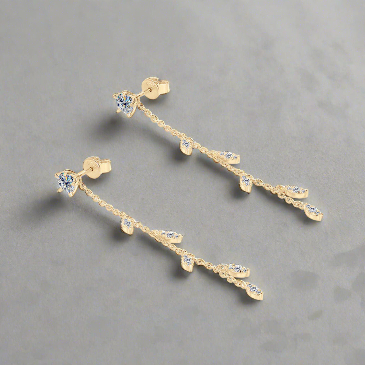 Moissanite drop earrings set in gold plated sterling leaf setting