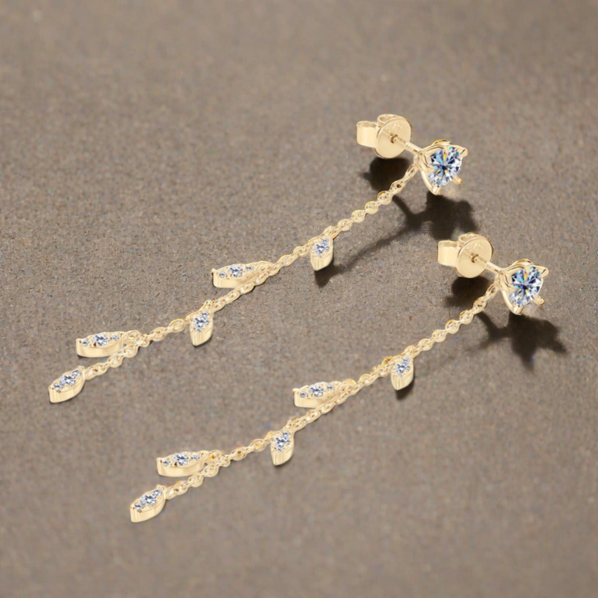 Moissanite drop earrings set in gold plated sterling leaf setting