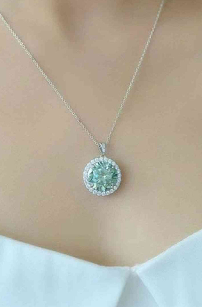 model wearing 10 carate green moissanite pendant in sterling silver setting
