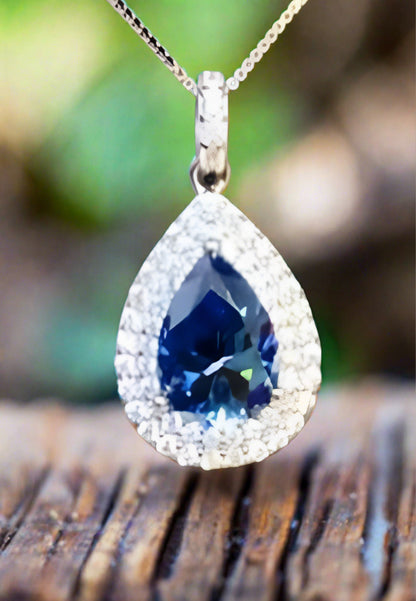 2 carat blue Moissanite teardrop pendant with zircon accent stones set in platinum plated sterling silver