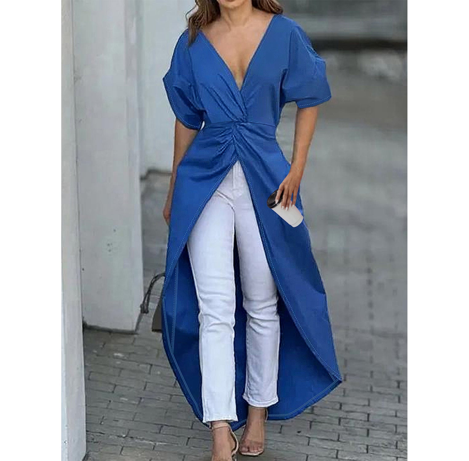 Woman outdoors wearing short sleeve blue high low blouse