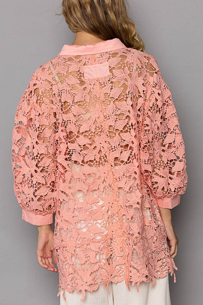 Model wearing peach coral lace shirt