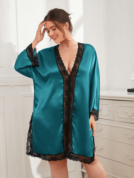 Woman standing in front of dresser in long sleeve plus size. thigh length,  teal nightdress with black lace trim