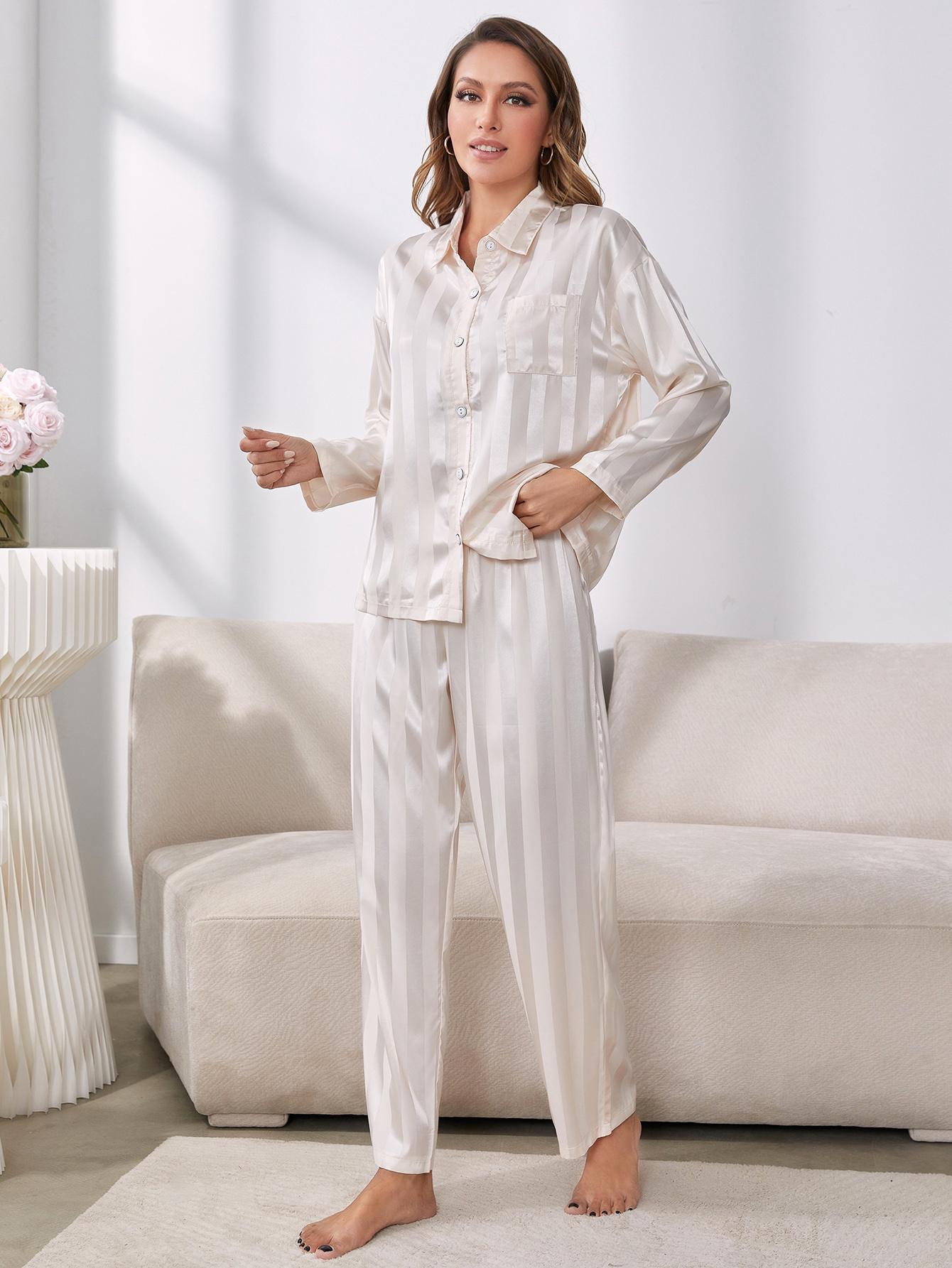 Model standing wearing white striped pajama set