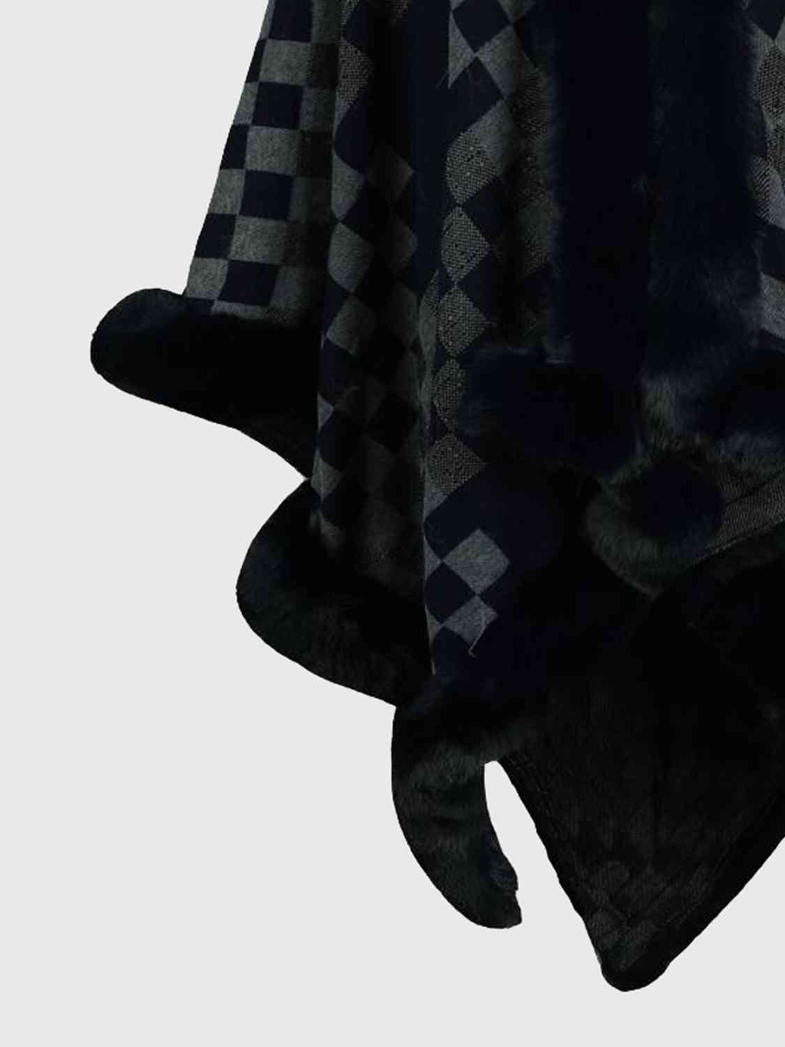 close up of checkered poncho with faux fur trim