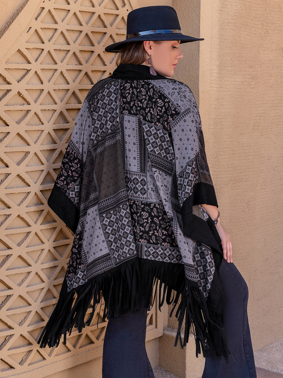 Back of Model wearing black plus size open front poncho cover up