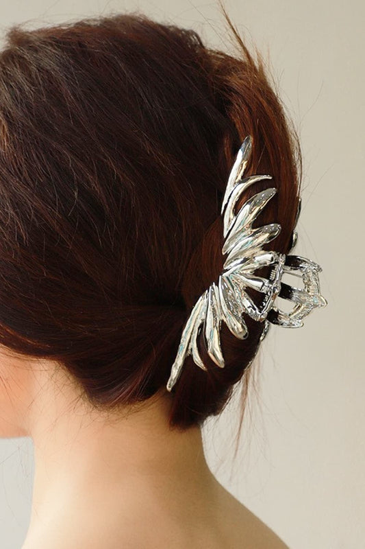 Woman wearing silver color polished claw clip.