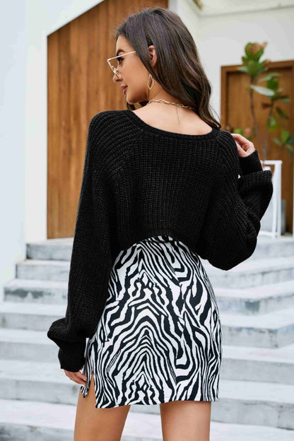back of model wearing cropped knitted cover up in black