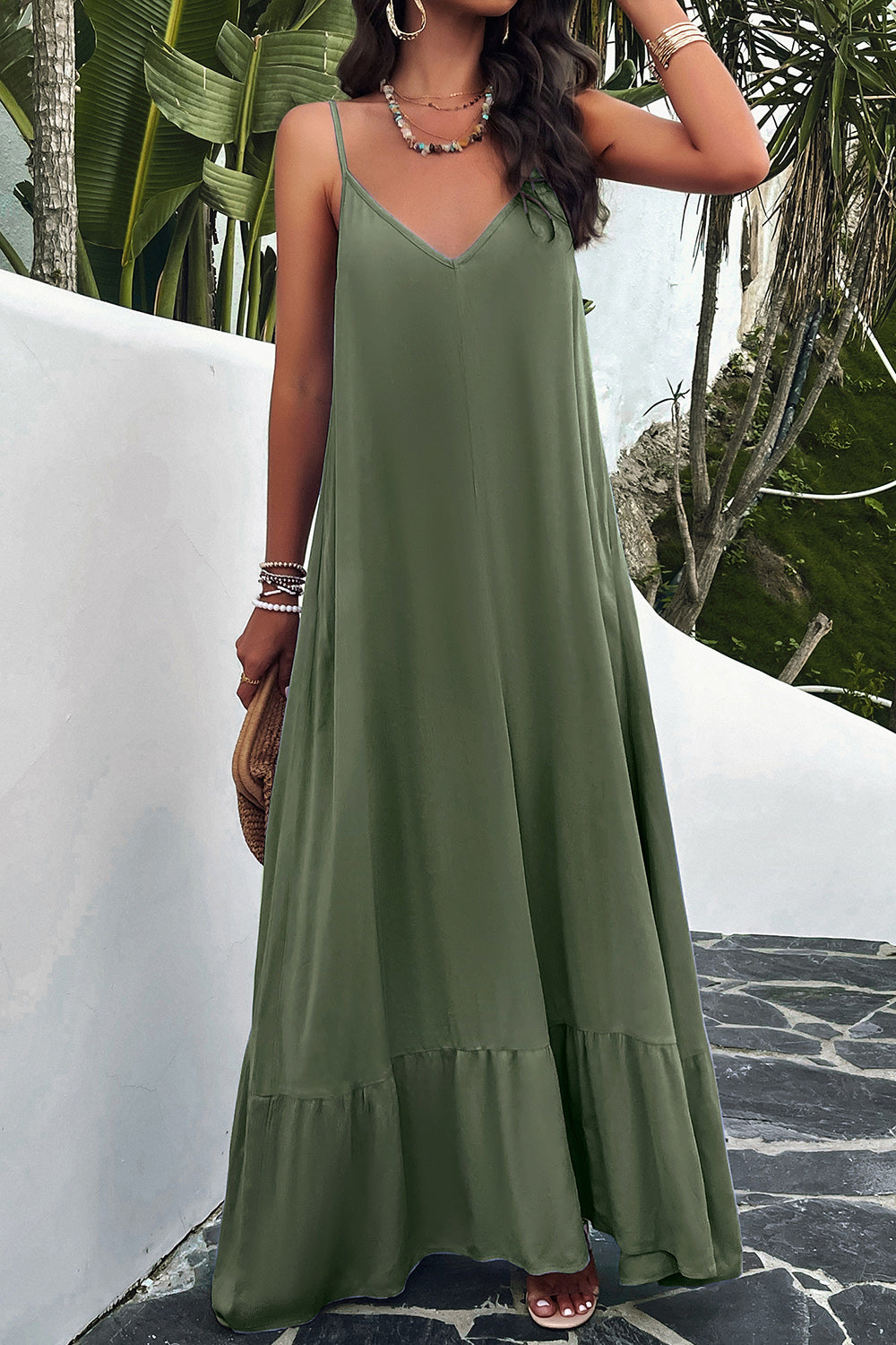 Model standing outside wearing green spaghetti strap loungedress