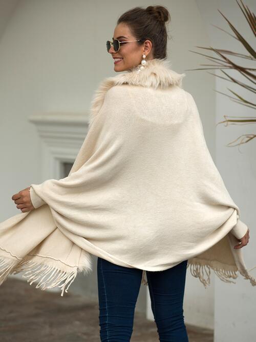 Back of Model wearing ivory fur trimmed open front poncho