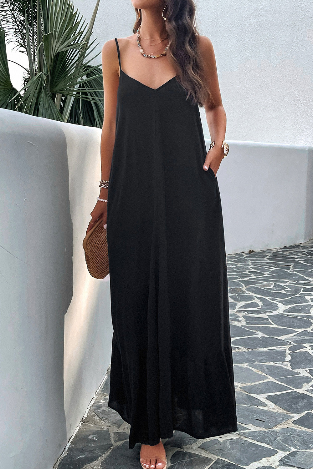 Model standing outside wearing black spaghetti strap loungedress