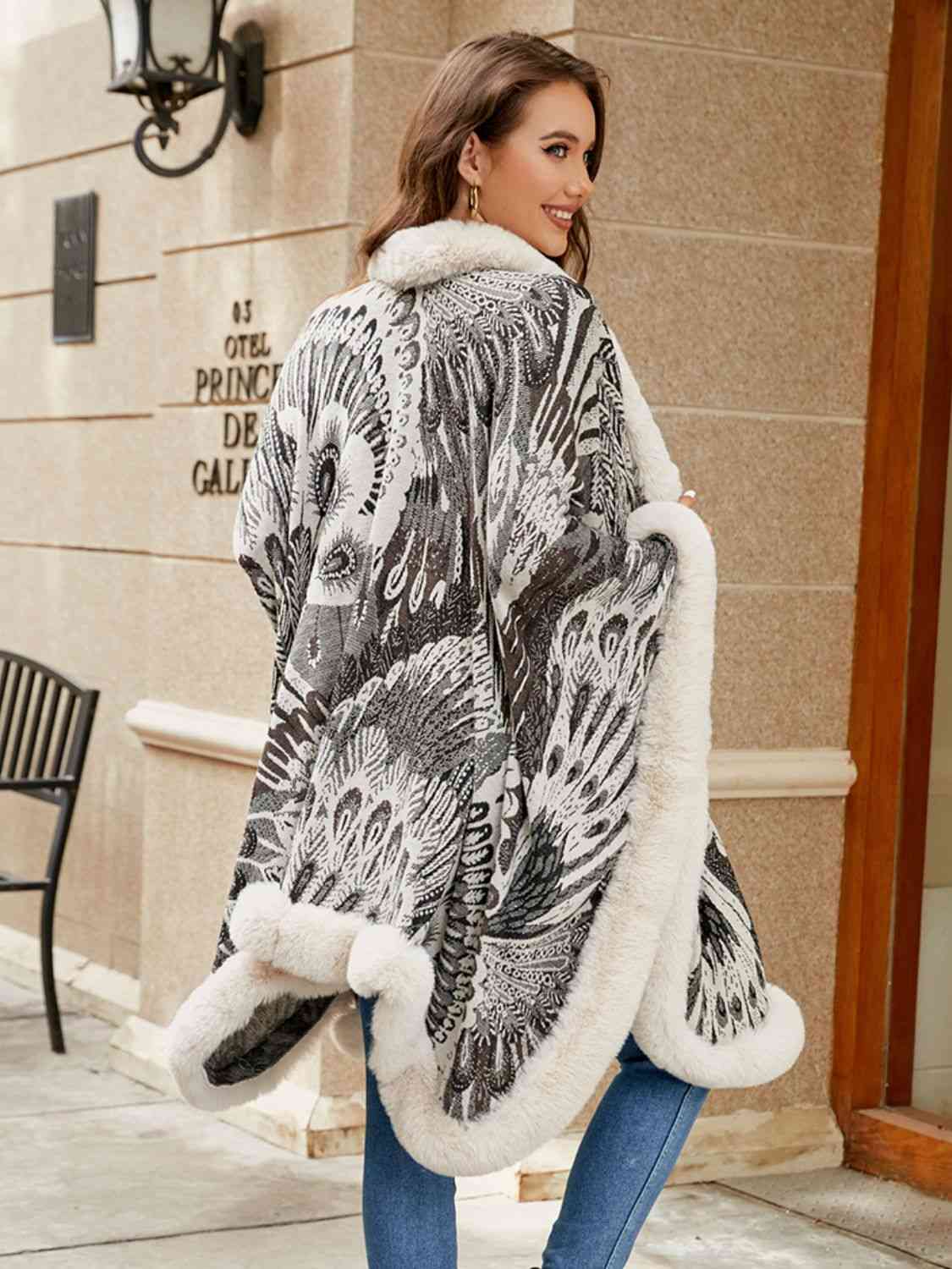 Back of Model wearing open front printed poncho with faux fur trim