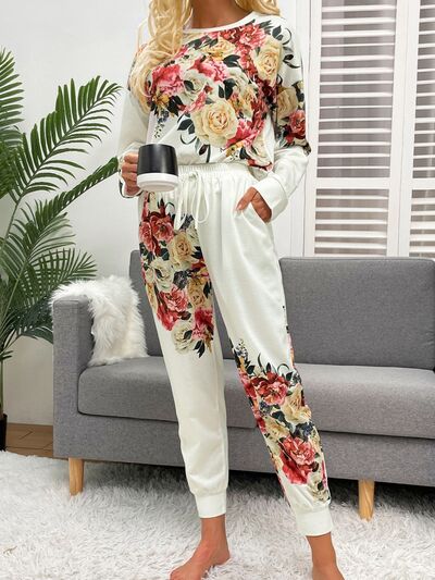 Model holding cup of coffee wearing white pajama set with flower print