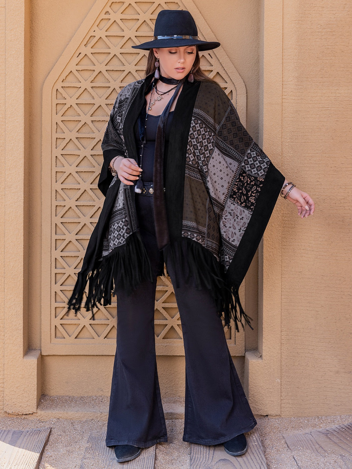 Model wearing black plus size open front poncho cover up