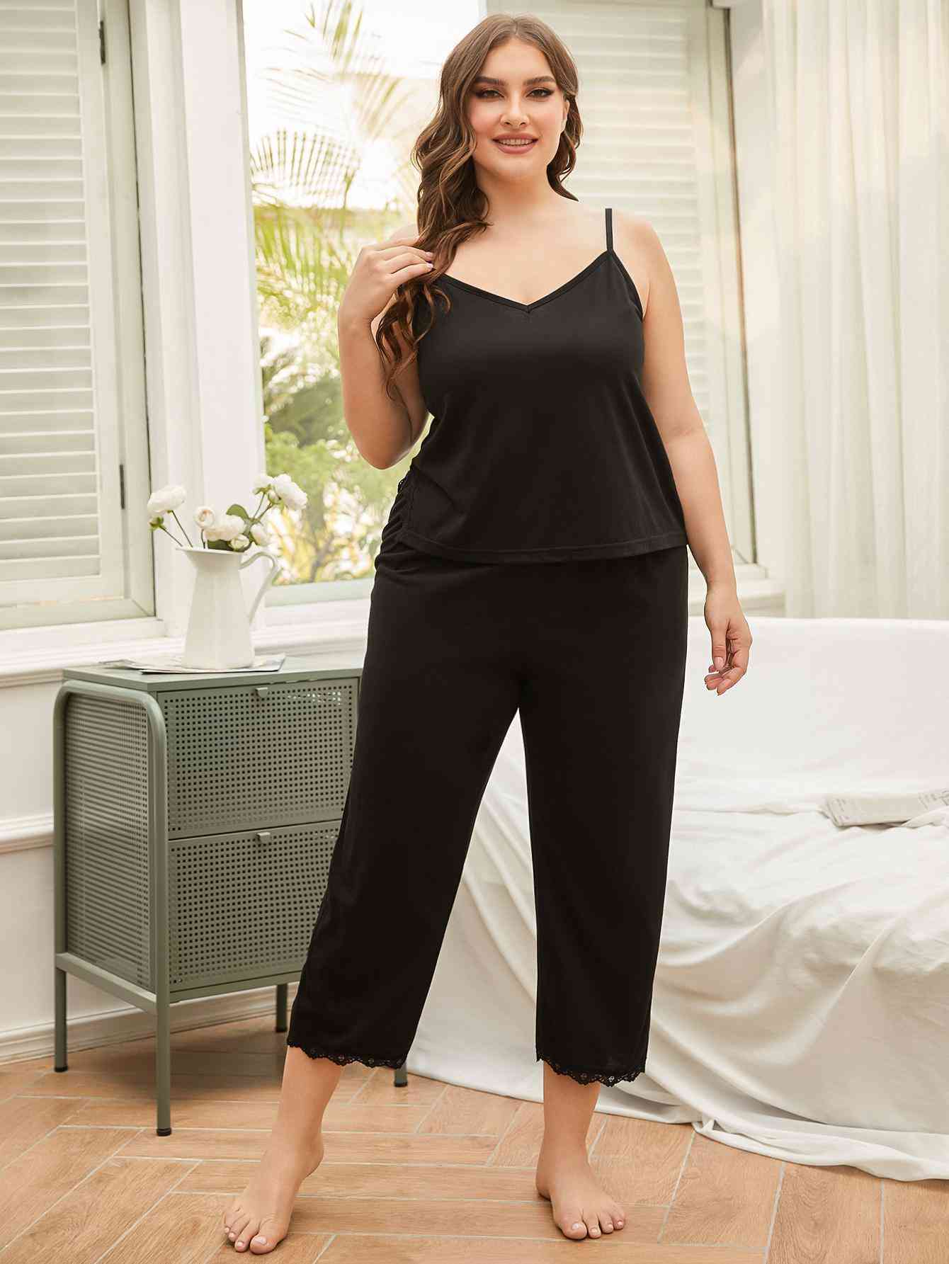 Model wearing black spaghetti strap pajama set