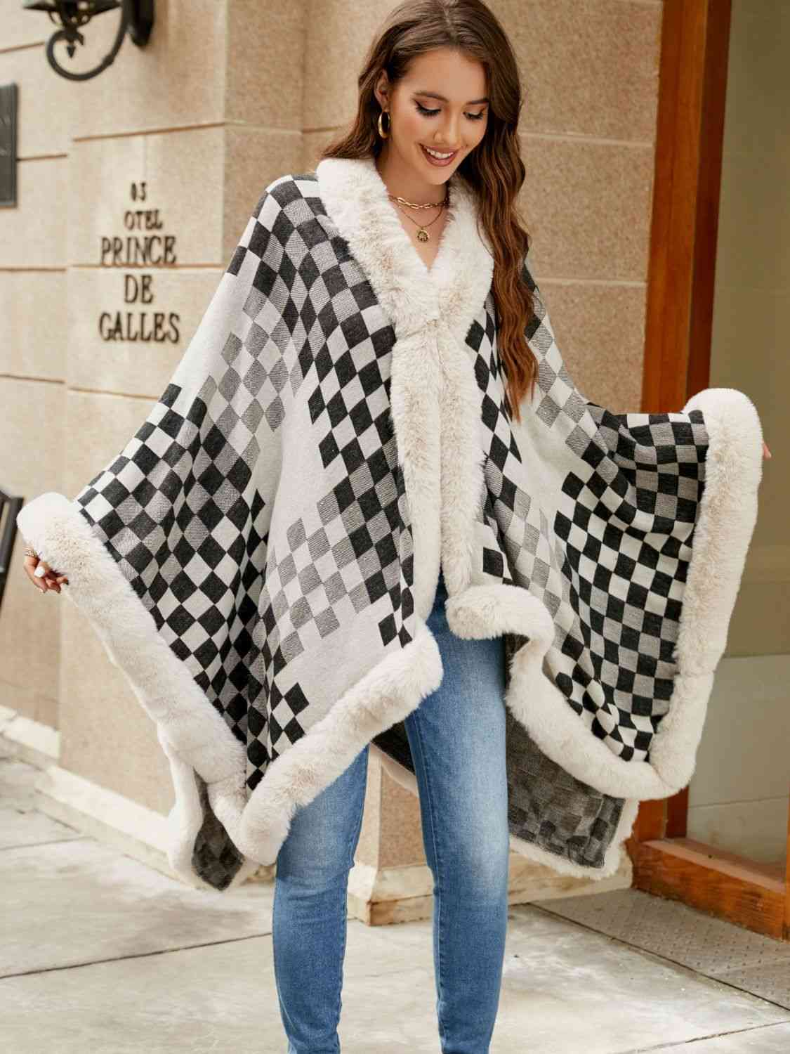 Model wearing checkered poncho with faux fur trim
