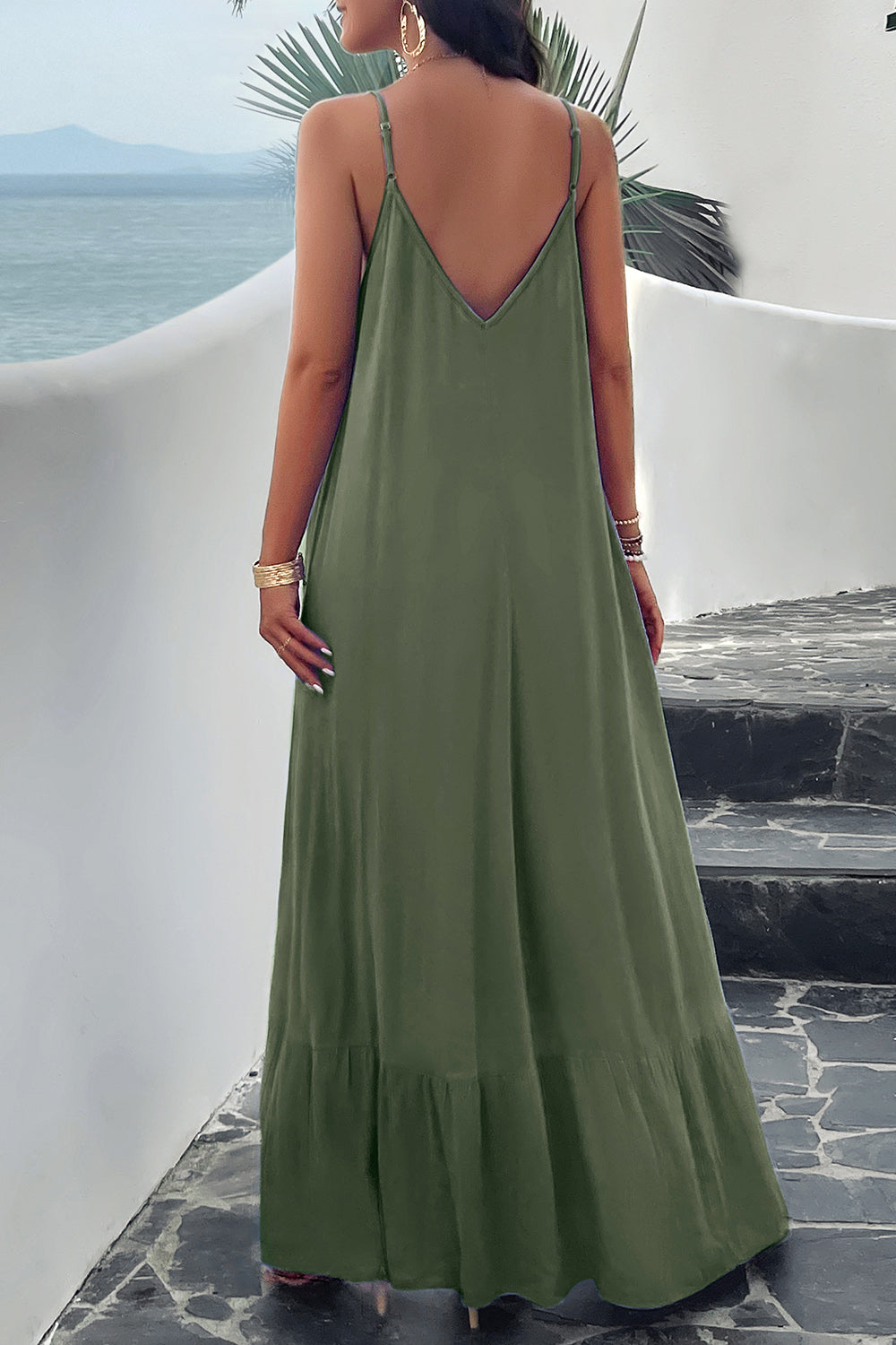 Back of model standing outside wearing green spaghetti strap loungedress