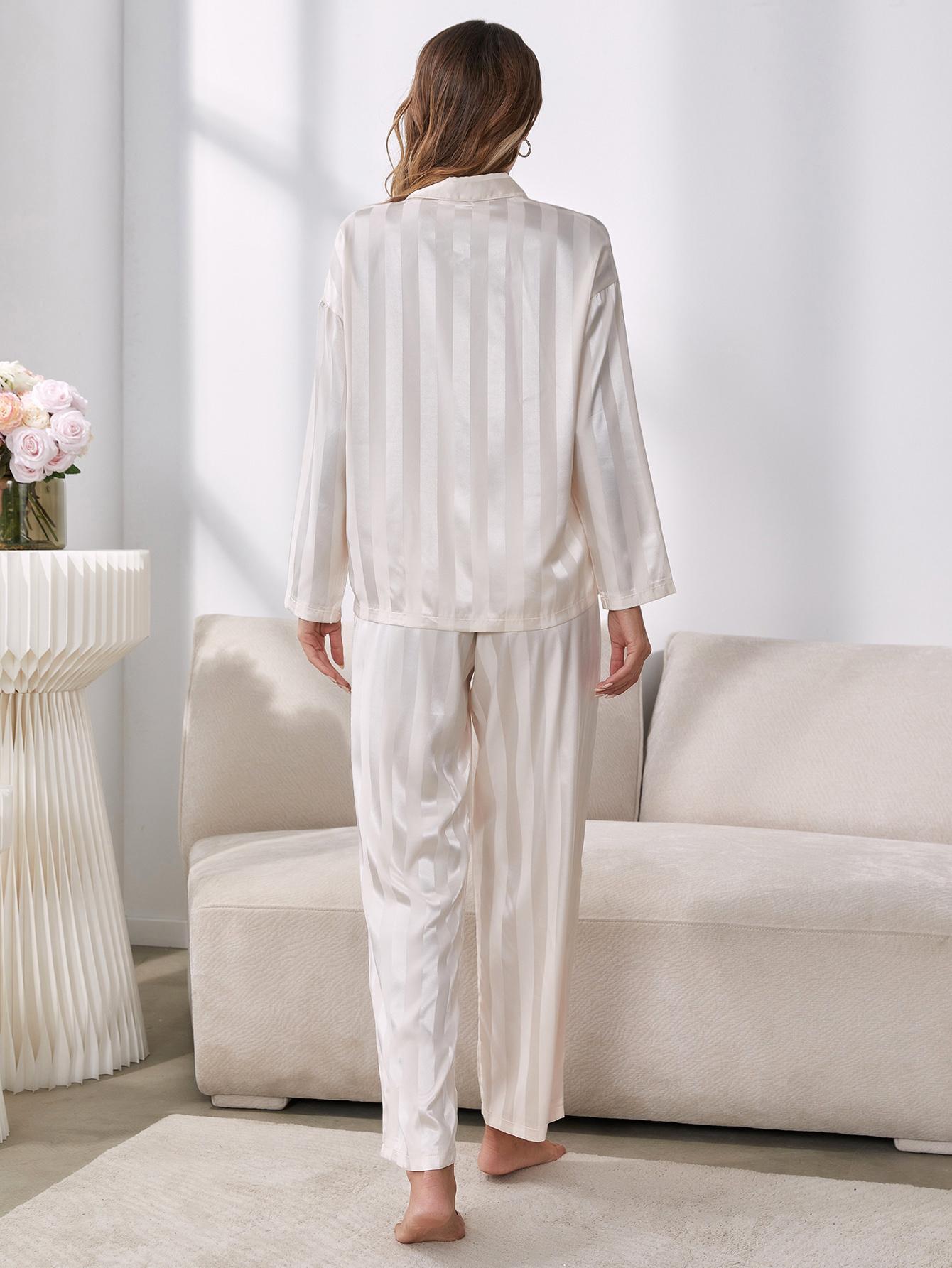 Back of Model standing wearing white striped pajama set