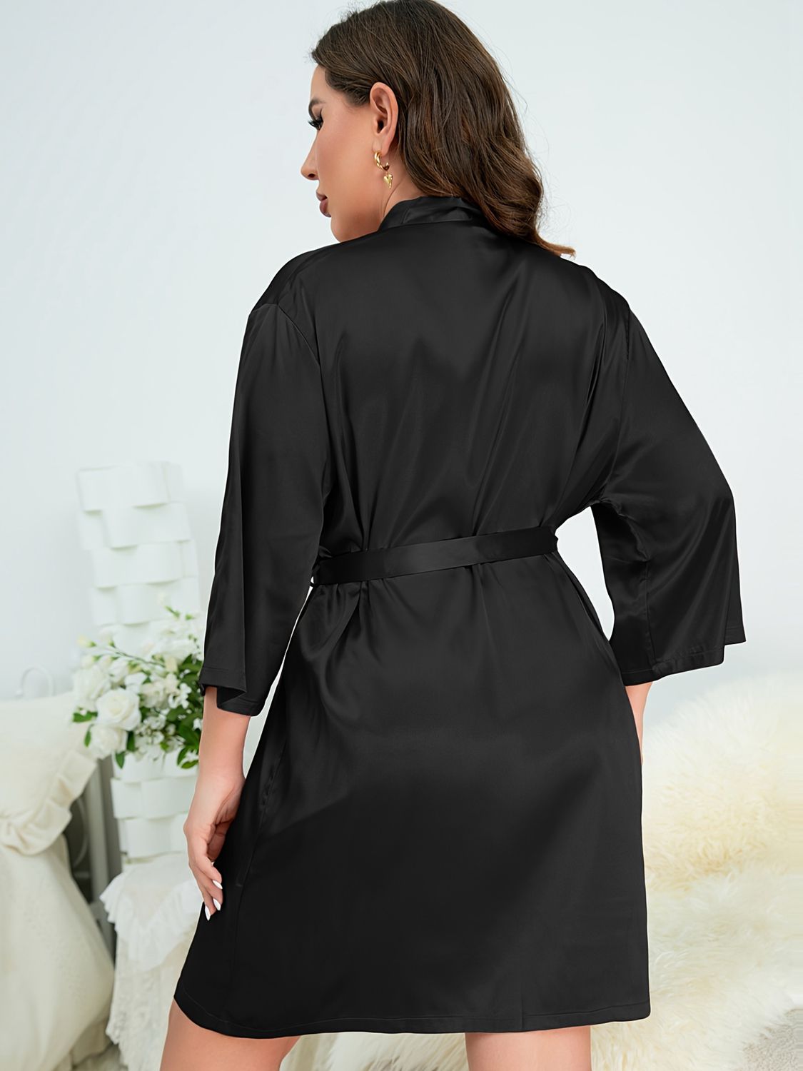 Back of model wearing black plus size robe