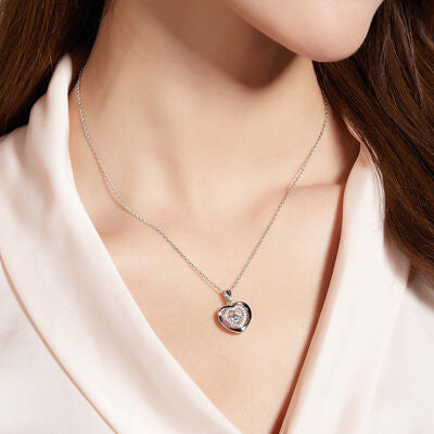 Model wearing Moissanite stone set in sterling silver heart pendant