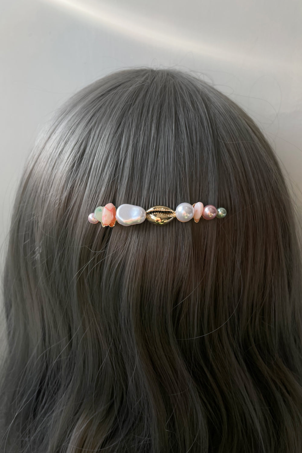 Woman wearing faux pearl multi-color hair pin